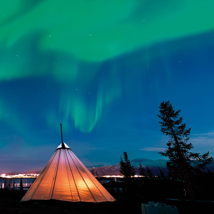 Aurora Borealis over lavvu tent in Tromso
